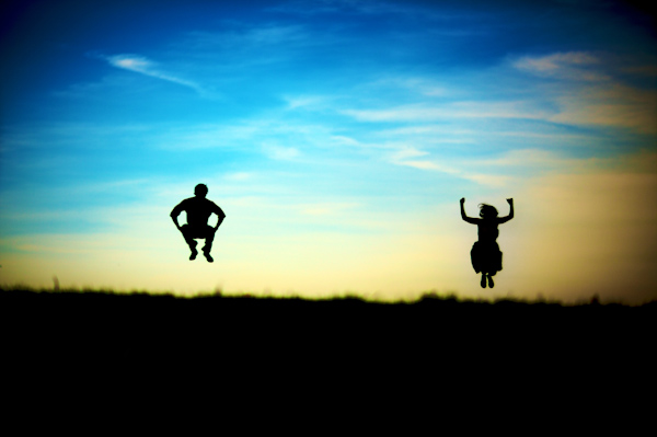 wedding photo by Kevin Weinstein Photography - fun engagement photo of silhouetted couple jumping 